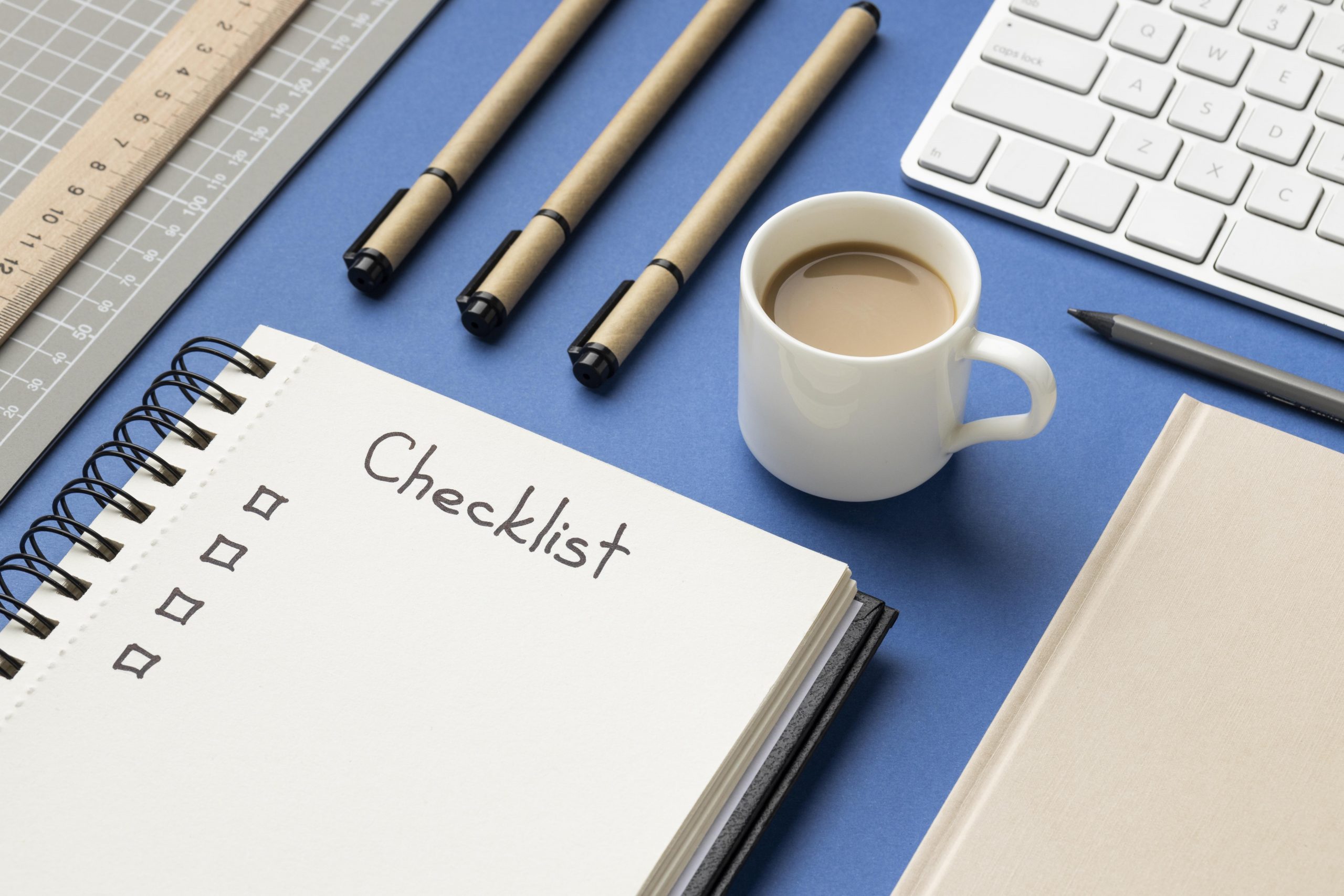 notizbuch von oben mit checkliste auf dem schreibtisch scaled